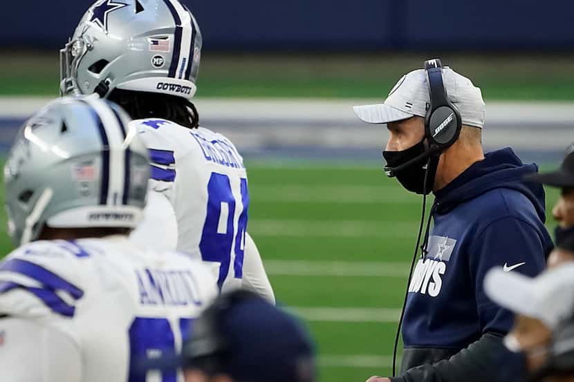 Cowboys defensive coordinator Mike Nolan works on the sideline during the second quarter of...