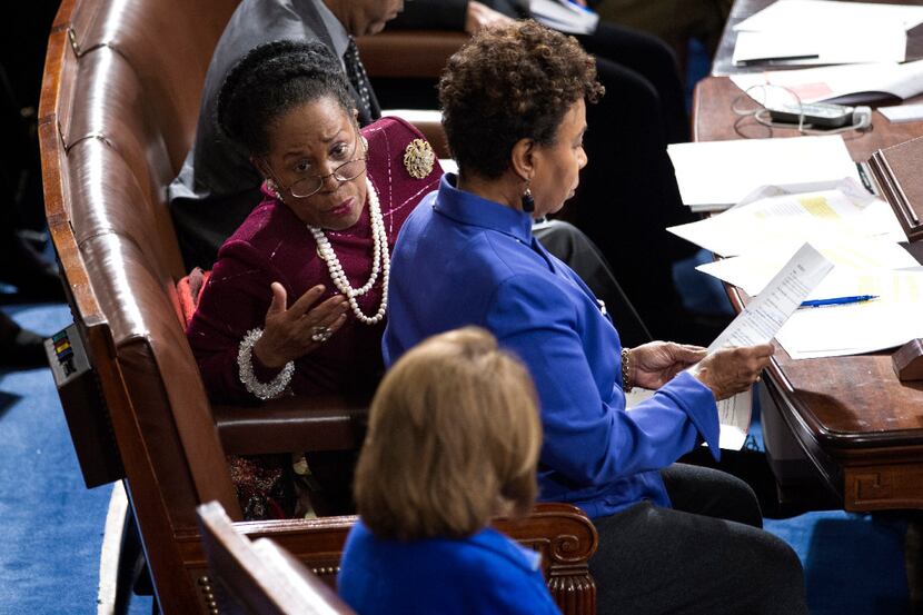 Rep. Shelia Jackson Lee, D-Houston, (top) talks with House Minority Leader Nancy Pelosi of...