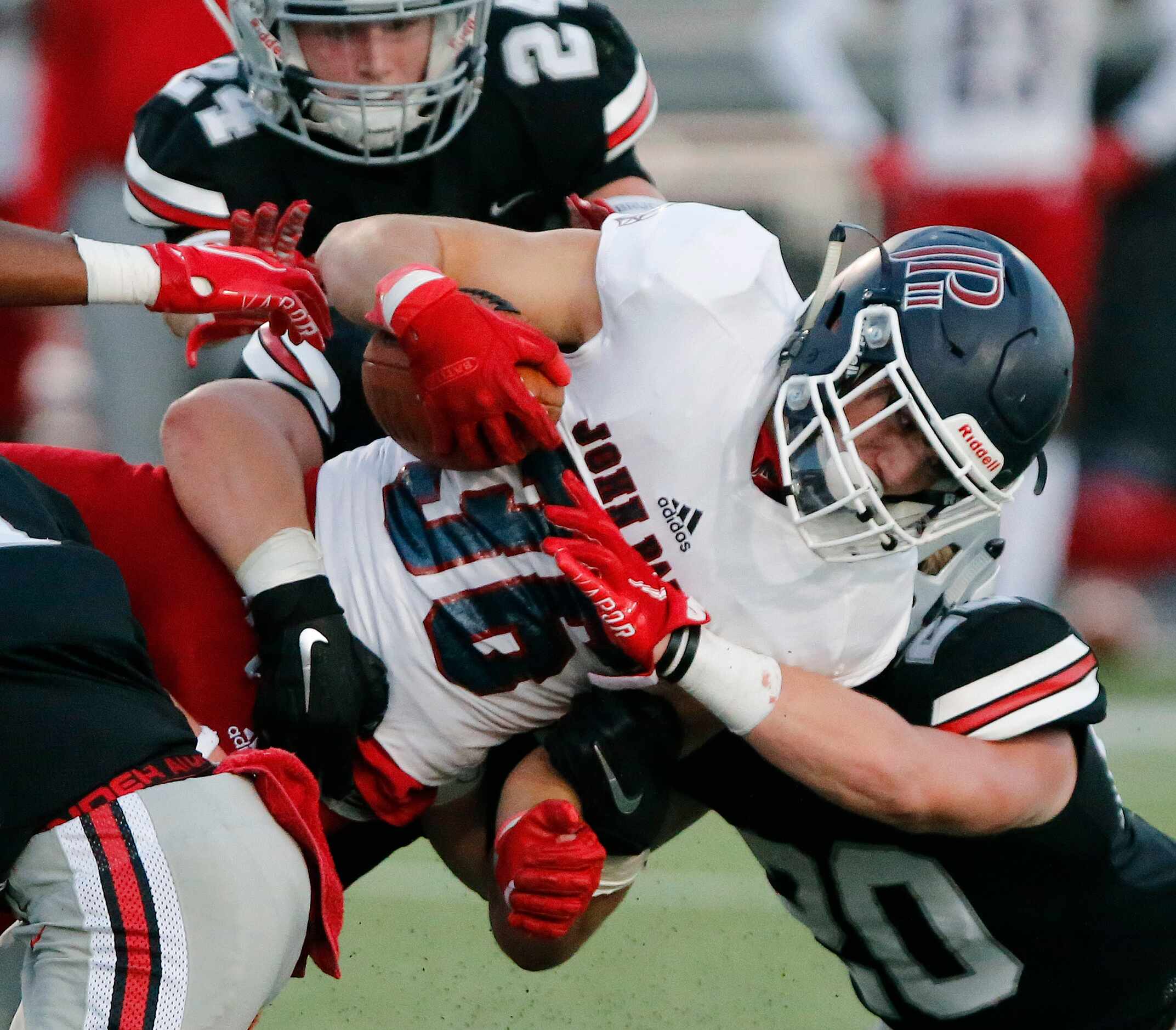 John Paul II High School running back Ben Boland (36) is tackled by Lovejoy High School...