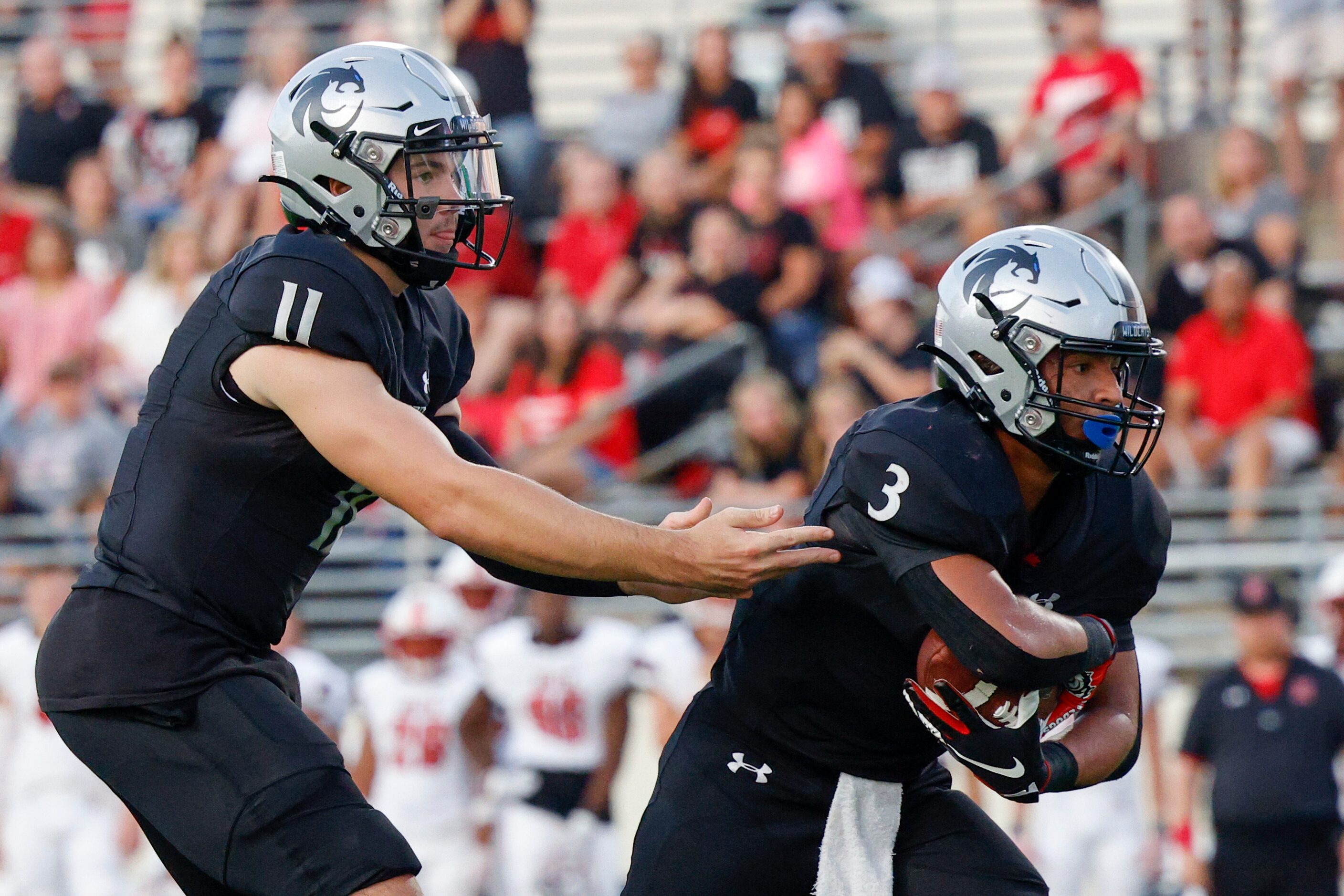 Denton Guyer quarterback Jackson Arnold (11) hands the ball off to running back Trey Joyner...