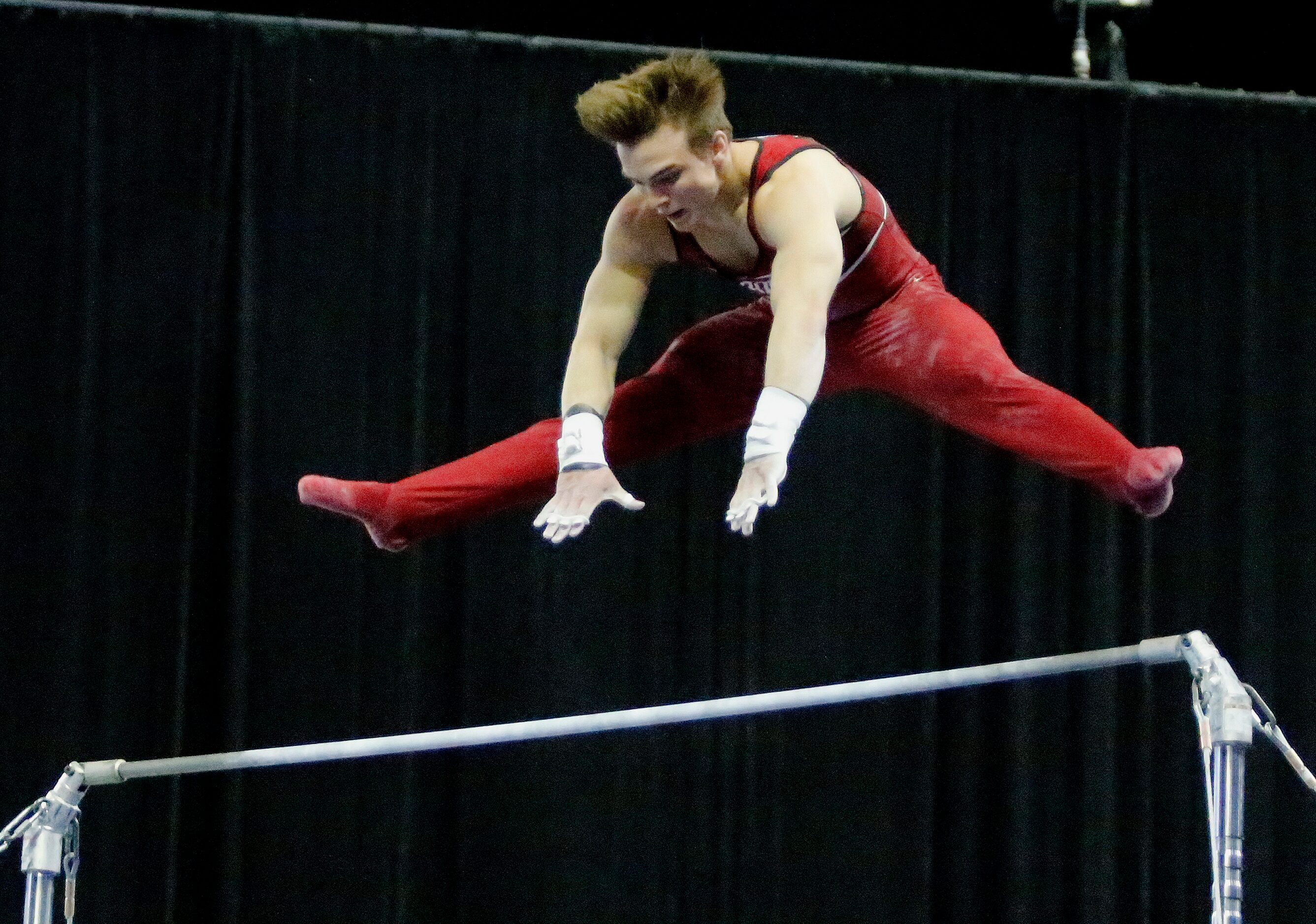  Curran Phillips of Stanford competes in the high bar during the mens finals at the USA...