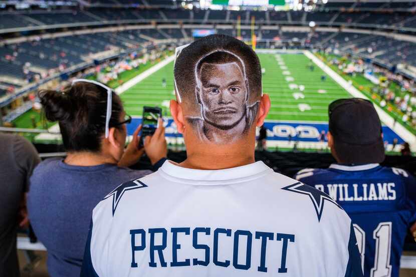 Juan Ramirez of  San Antonio shows off his haircut showing Dallas Cowboys quarterback Dak...
