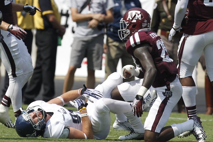 Rice Owls wide receiver Klein Kubiak (84) is hit hard by Texas A&M Aggies defensive back...