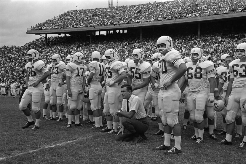 University of Texas coach Darrell Royal peers onto the Cotton Bowl turf during the game with...