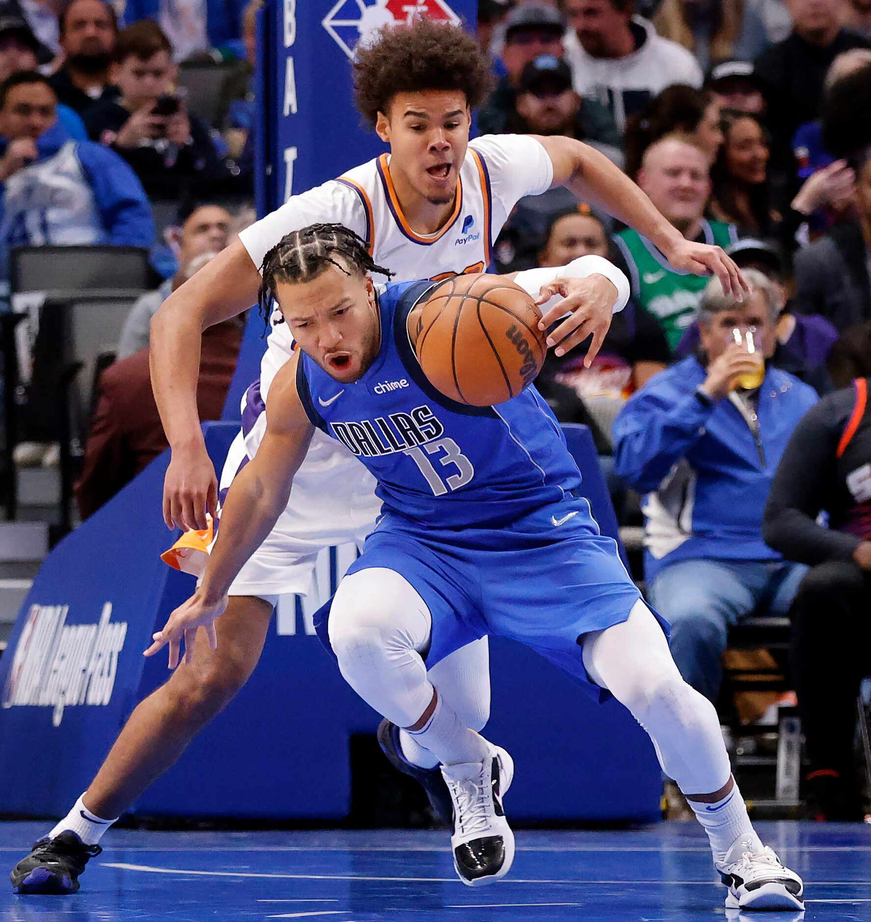 Dallas Mavericks guard Jalen Brunson (13) falls backward into Phoenix Suns forward Cameron...