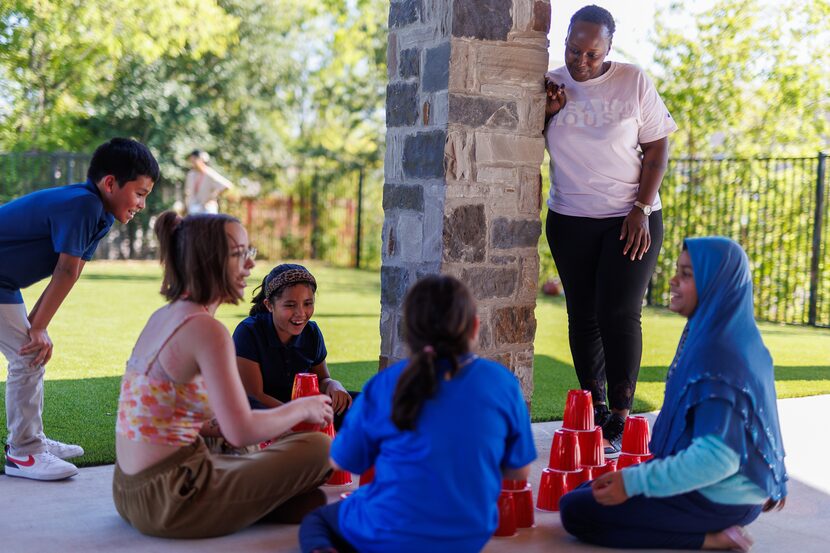 Christelle Agasaro (top right), family outreach coordinator, watched over students playing...