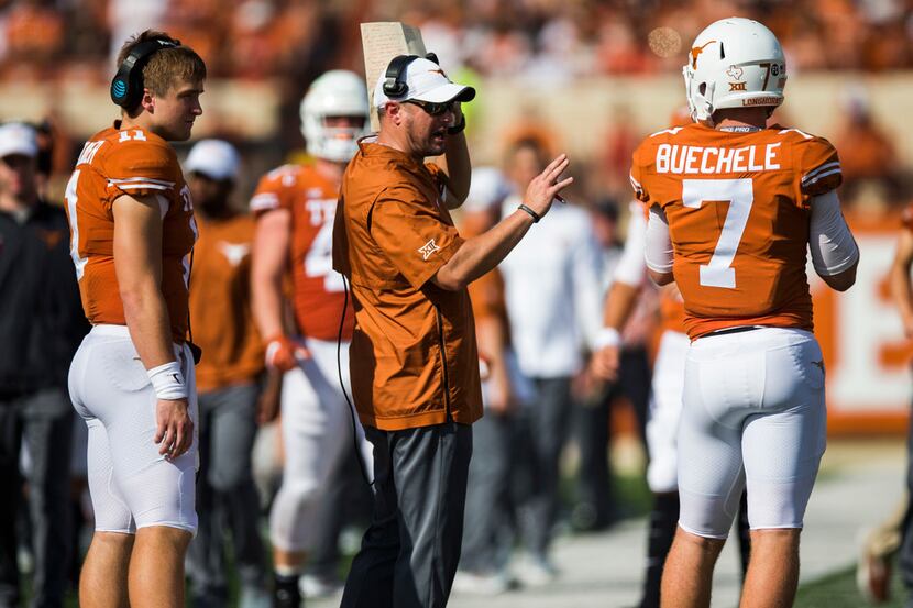 Texas Longhorns head coach Tom Herman talks with quarterback Sam Ehlinger (11) and...