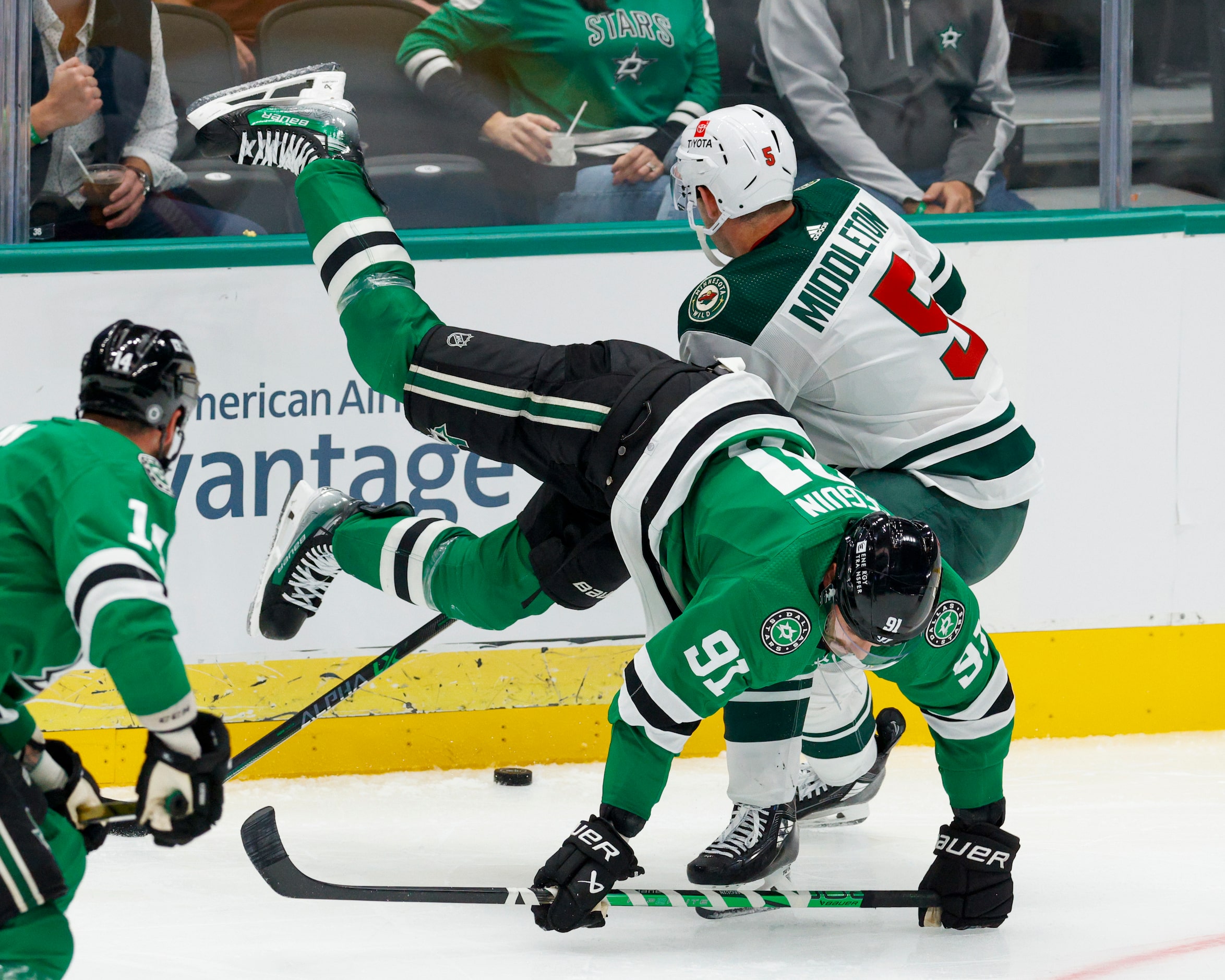 Dallas Stars center Tyler Seguin (91) is upended by Minnesota Wild defenseman Jake Middleton...