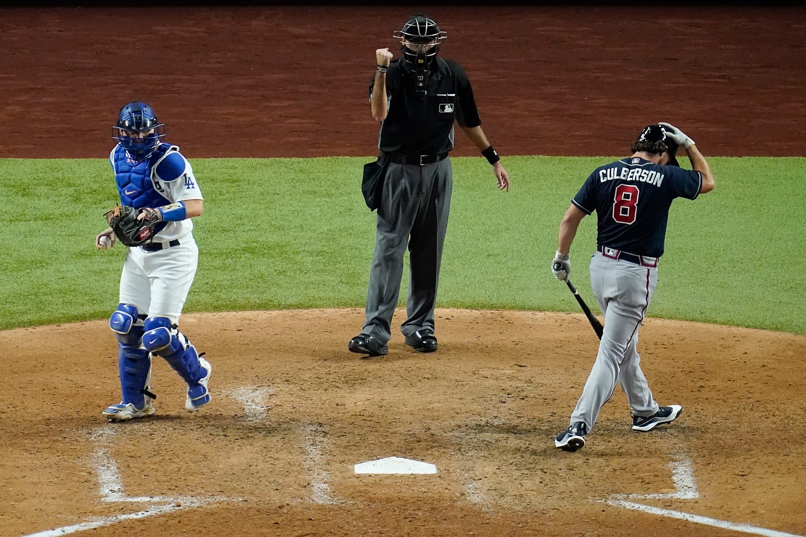 Umpire Pat Hoberg makes the call as Atlanta Braves pinch hitter Charlie Culberson (8)...