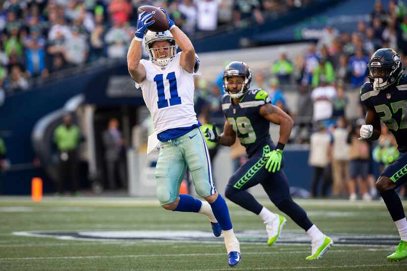 Dallas Cowboys wide receiver Cole Beasley (11) hauls in a pass past Seattle Seahawks...