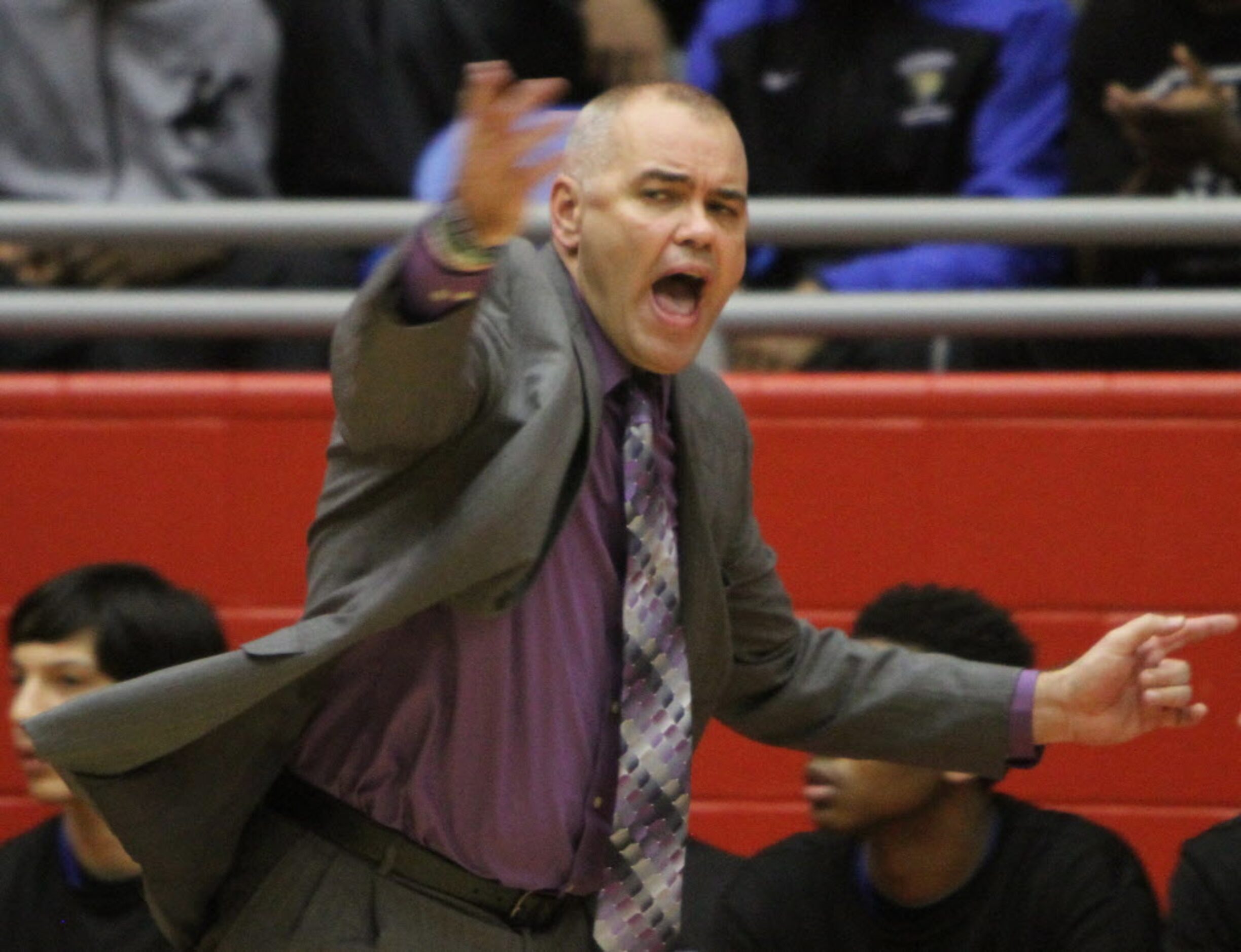 Mansfield Summit head coach Jason Mutterer leads his team as he enthusiastically calls for a...