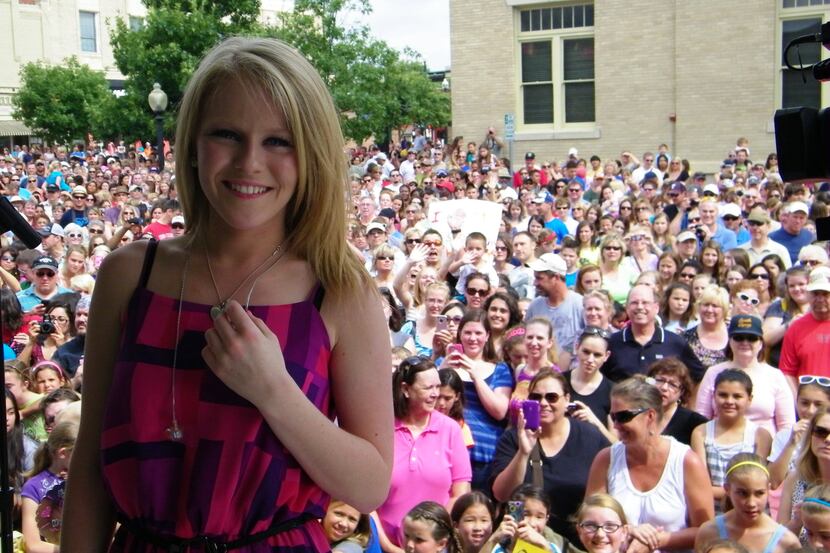 McKinney resident Hollie Cavanagh stands in front of thousands of fans who welcomed her home...