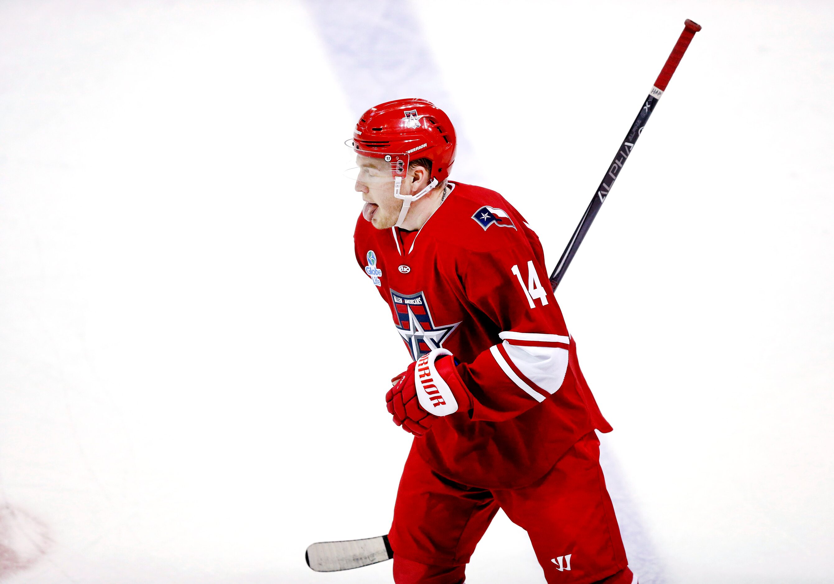 Allen Americans defenseman Les Lancaster sticks out his tongue after scoring a first period...