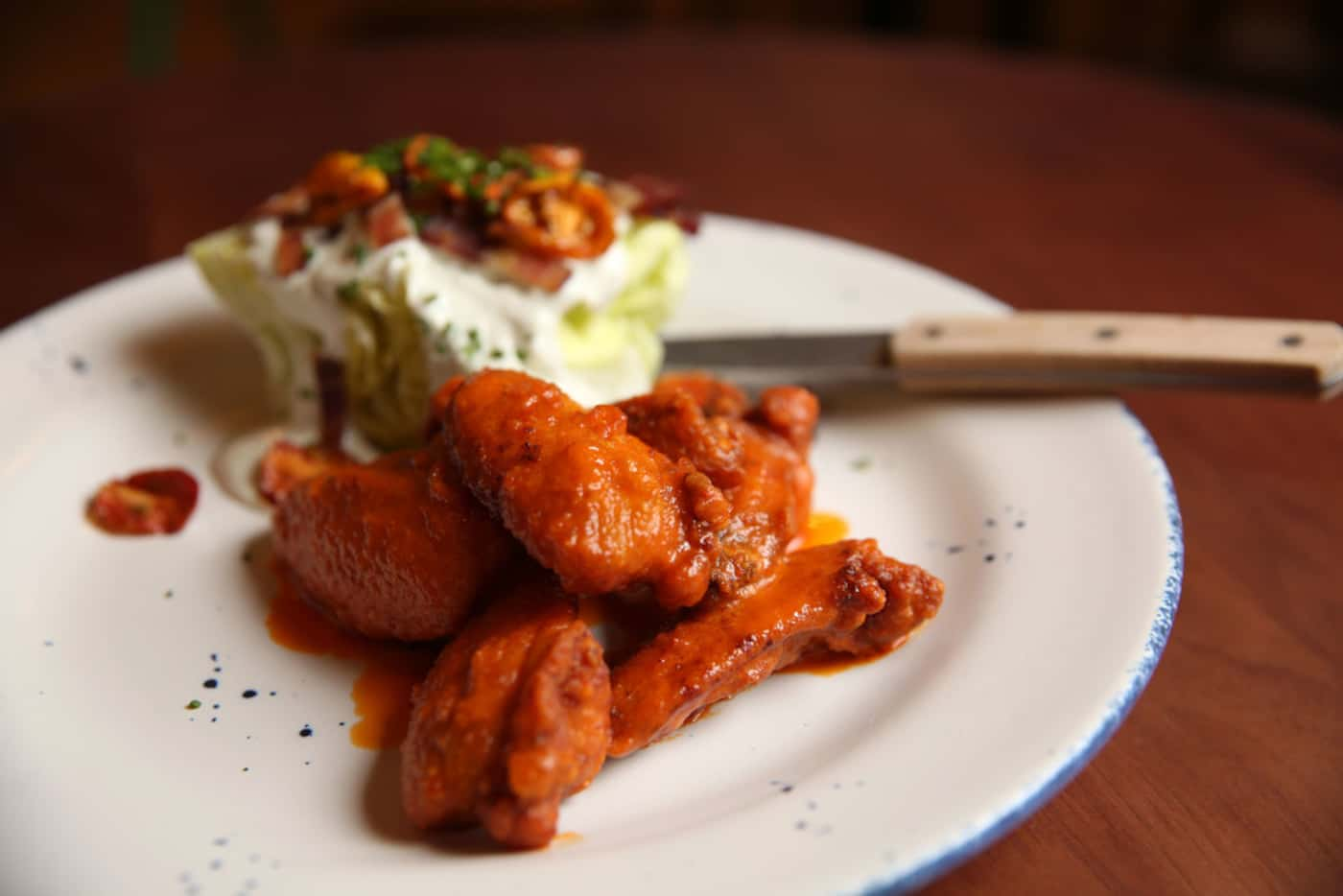 Crispy chicken wings with Calabrian chili and iceberg wedge from Scout at The Statler Hotel...