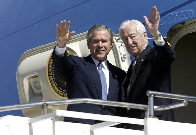 President George W. Bush and then-Rep. Ralph Hall waved as they arrive on Air Force One at...