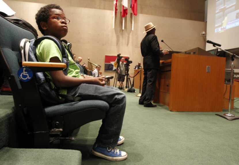 David Williams, 12, waits for his turn to speak at a Dallas City Council meeting, which he...