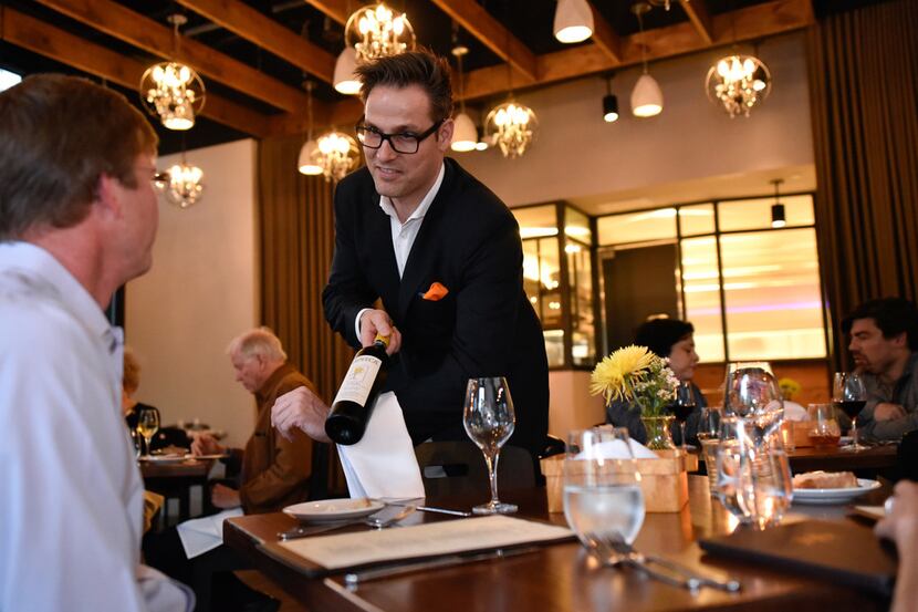 It's half price on Tuesday: Roger Bissell serves a bottle from the cellar at Mille Lire in...