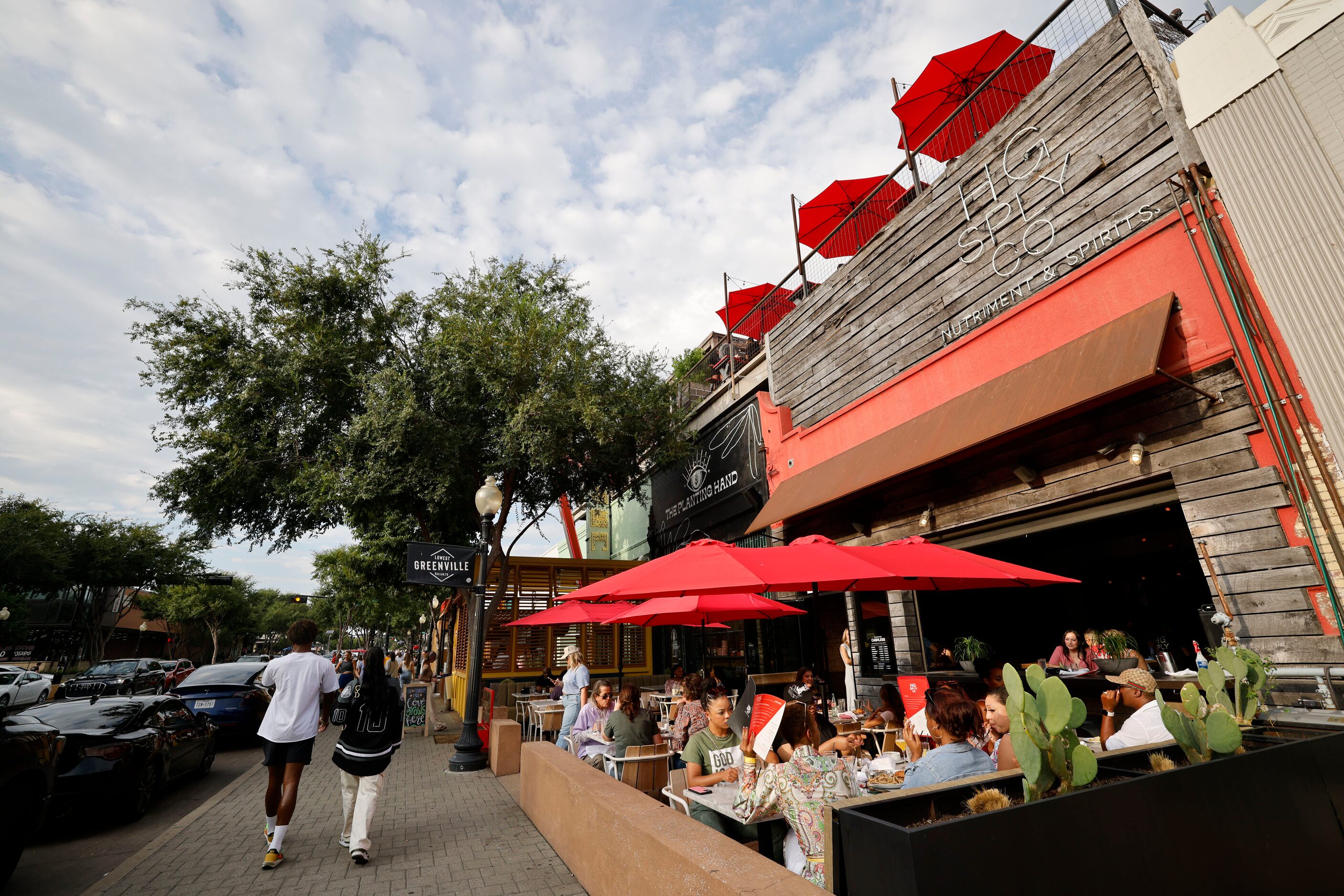 People have dinner on the patio at HG Sply Co. in the Lower Greenville neighborhood in...