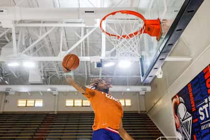 Kimball basketball player Arterio Morris dunks the basketball during a photoshoot in Dallas...