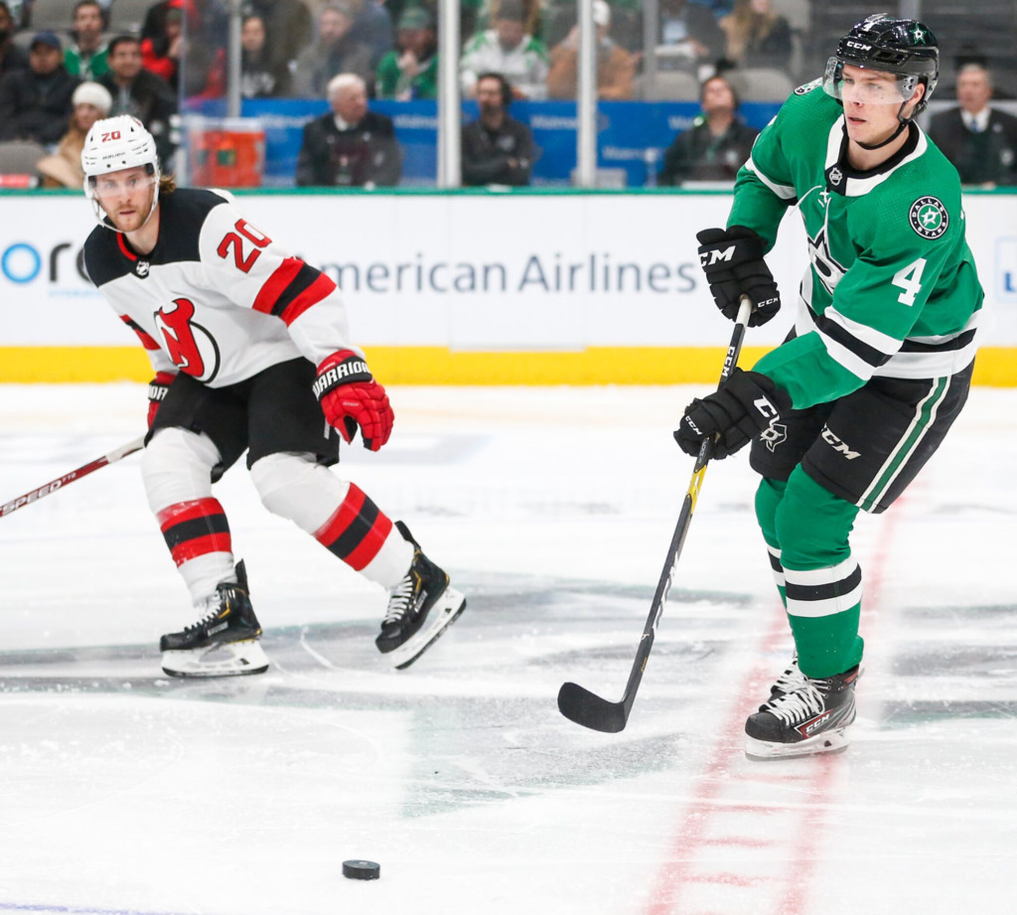 Dallas Stars defenseman Miro Heiskanen (4) makes a break past New Jersey Devils center Blake...