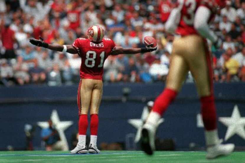 San Francisco receiver Terrell Owens  [ 81 ] gestures to the crowd at midfield after scoring...