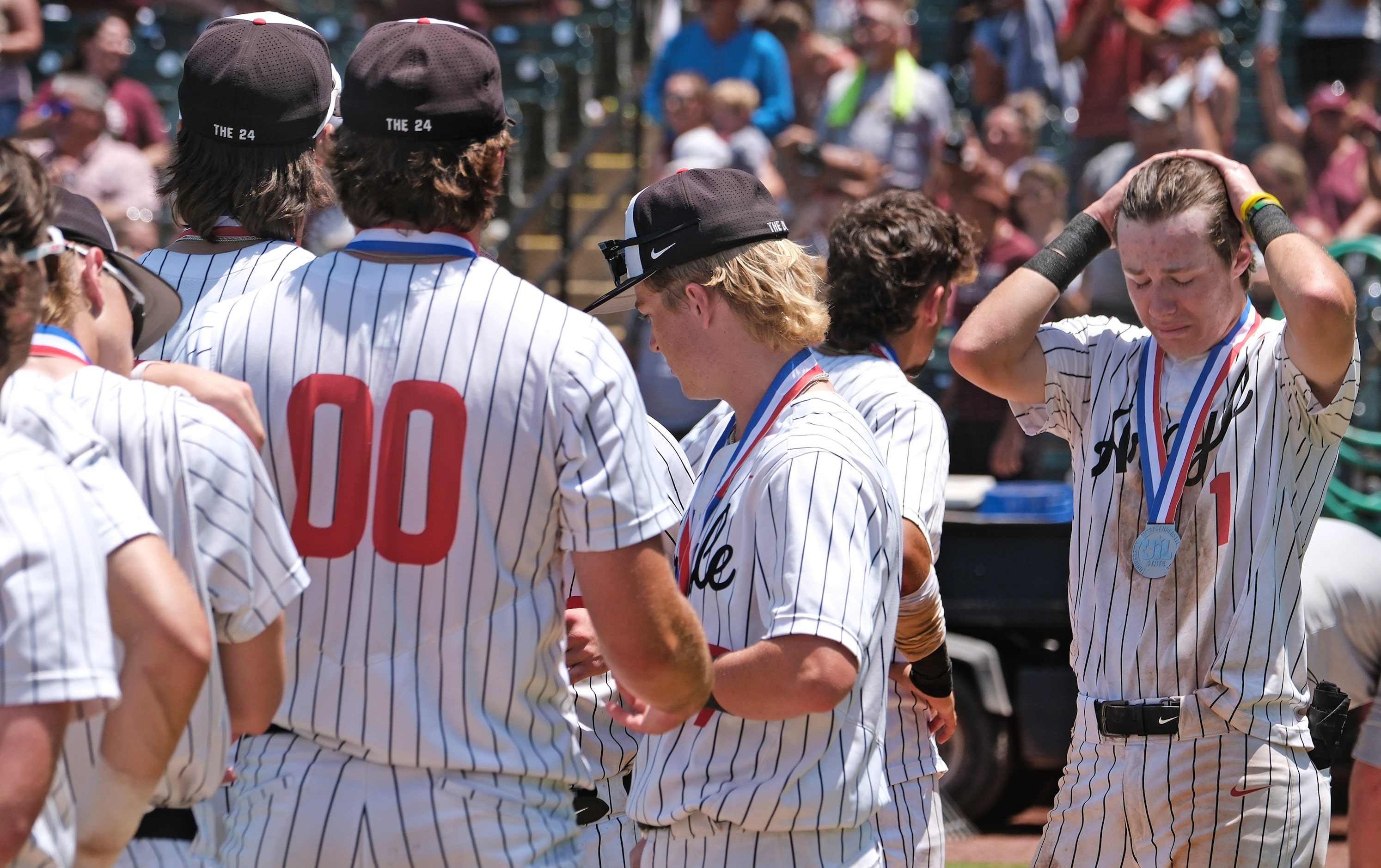 Argyle Grady Emerson, (1), over come with emotion stands with teammates after receiving...