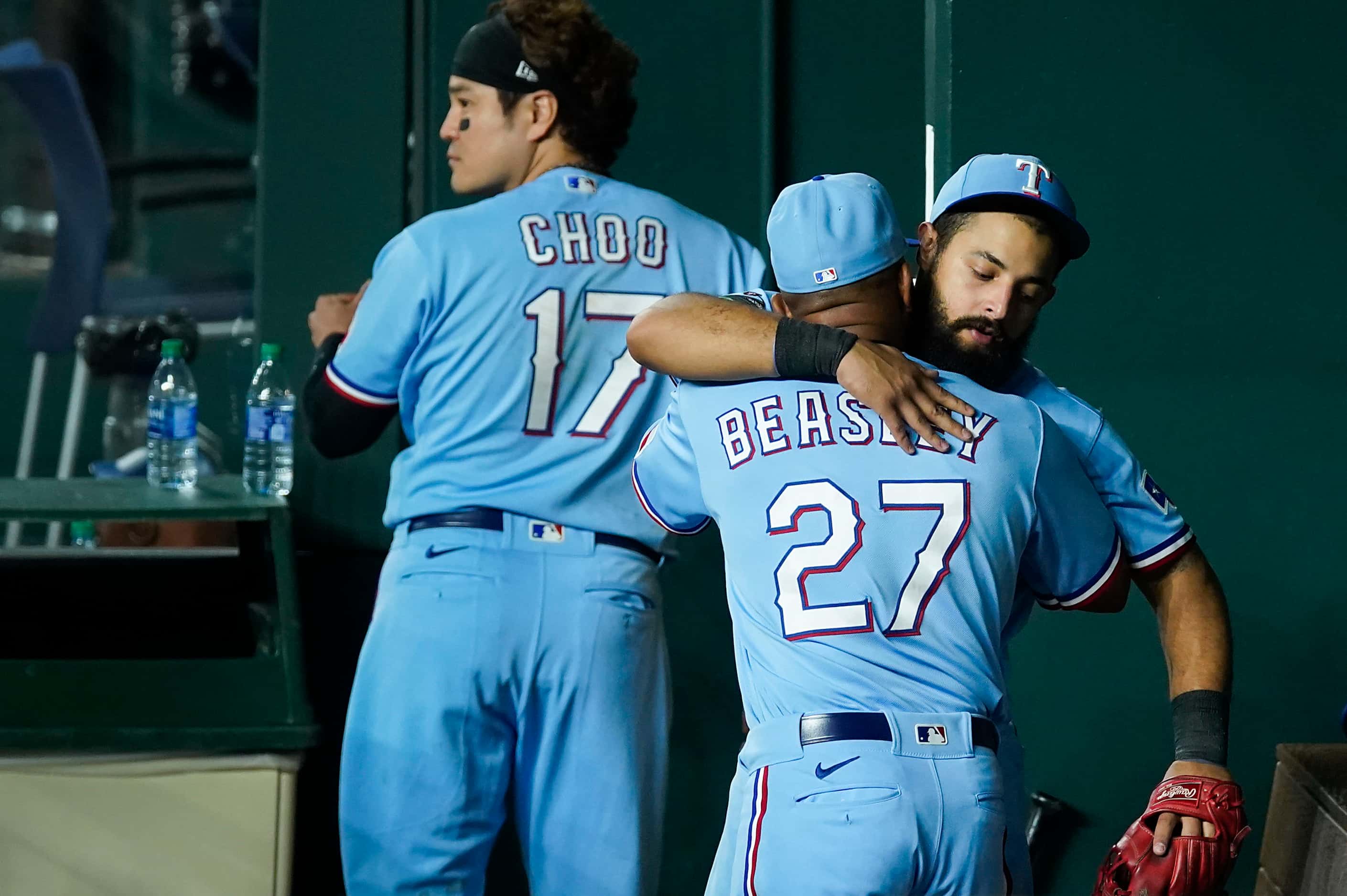 Texas Rangers second baseman Rougned Odor hugs third base coach Tony Beasley in the dugout...