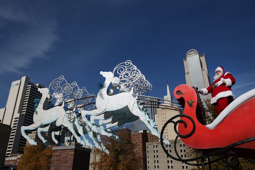 Santa Claus looks down at spectators along the parade route during the 28th annual...