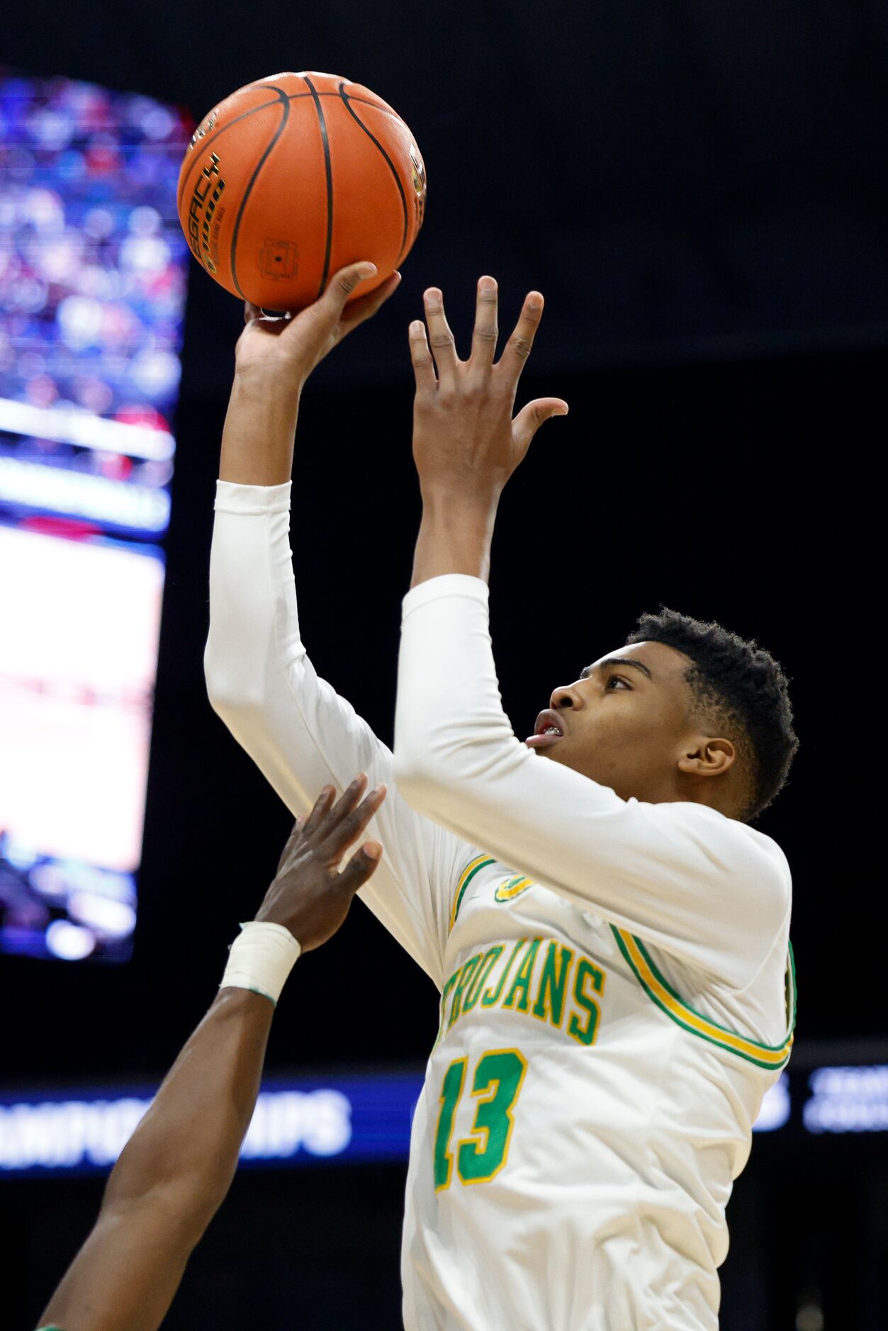 Madison forward Rodney Geter (13) shoots the ball over a San Antonio Cole defender during...