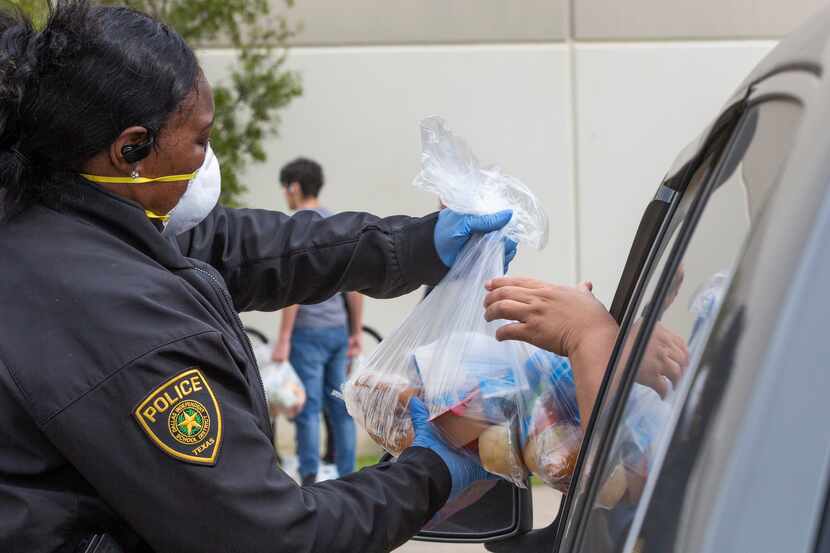Dallas police Officer Sherneka Coleman distributed meals at Medrano Middle School in Dallas...