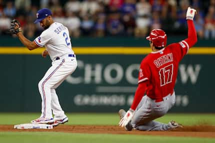 Texas Rangers second baseman Marcus Semien (2) tags second base to force out a sliding Los...