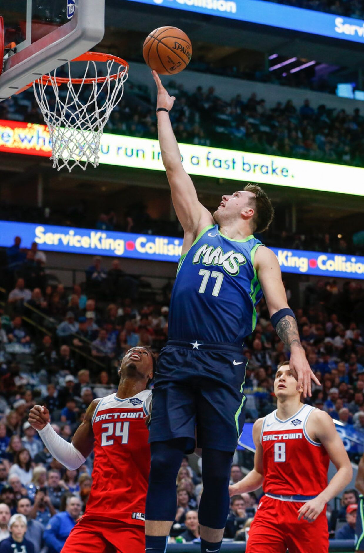 Dallas Mavericks forward Luka Doncic (77) goes to the basket over Sacramento Kings guard...