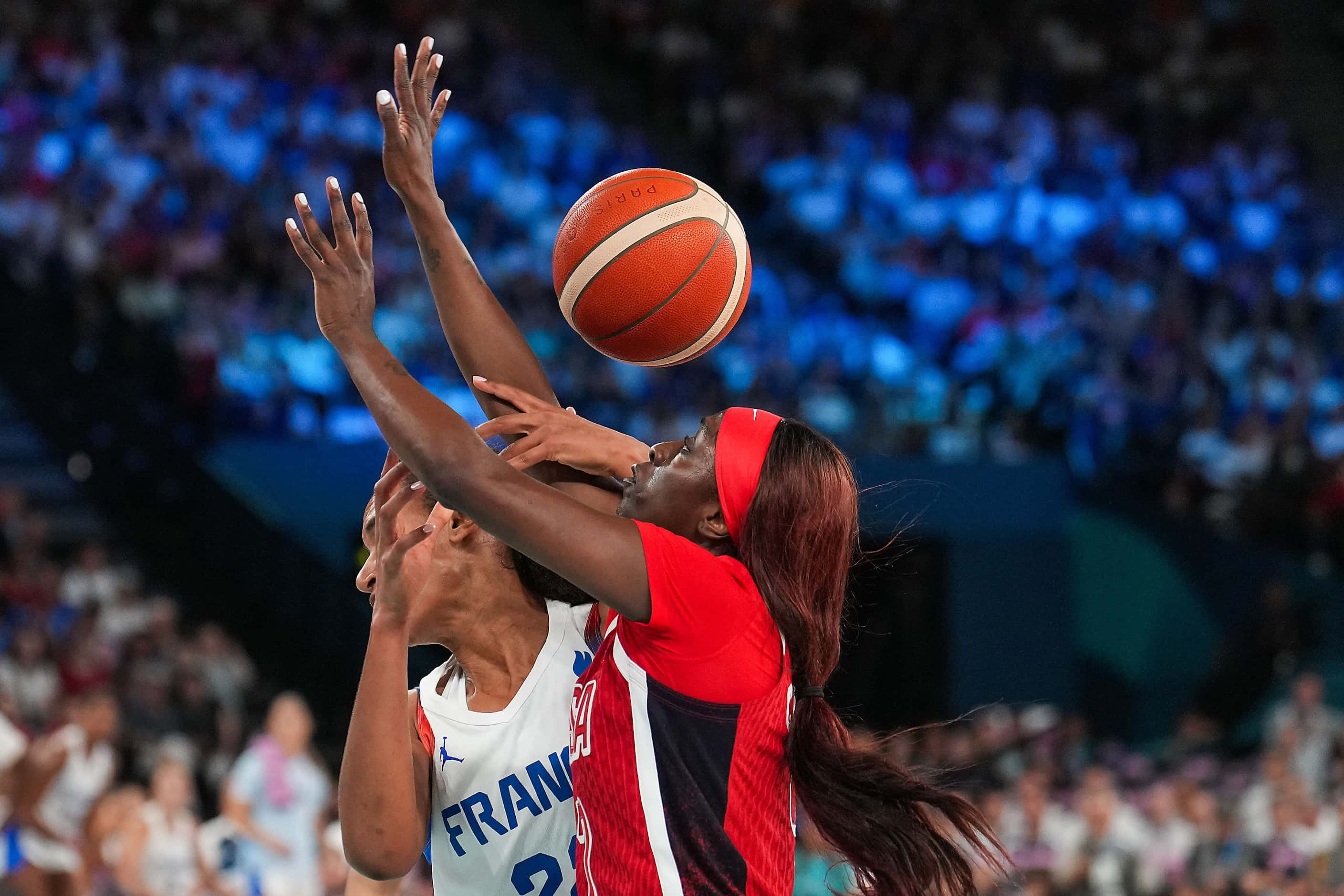 Kahleah Copper (7) of the United States knocks the ball away from Marieme Badiane (22) of...