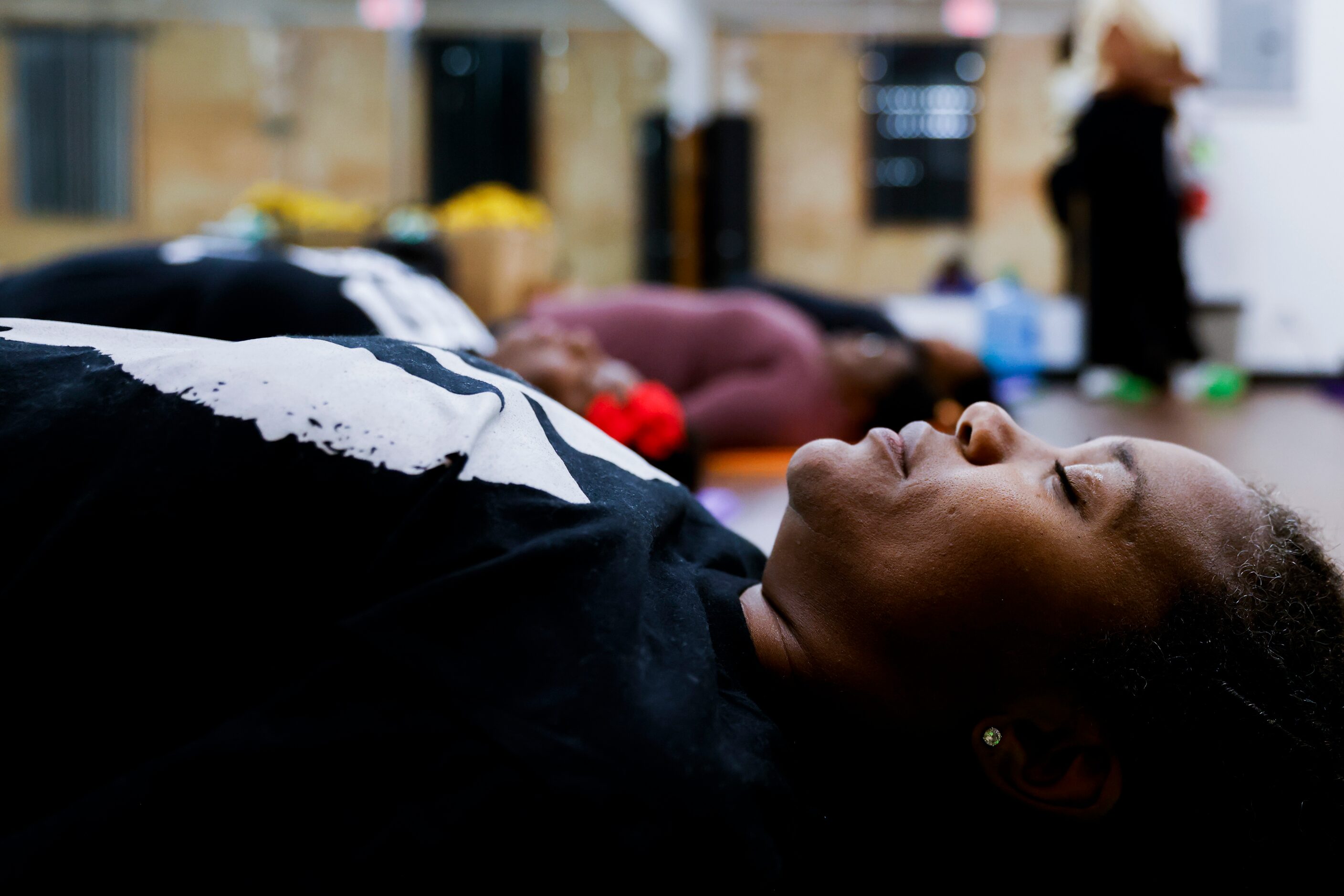 Member Tara Robinson closes her eyes as she participates in a yoga session at Abounding...