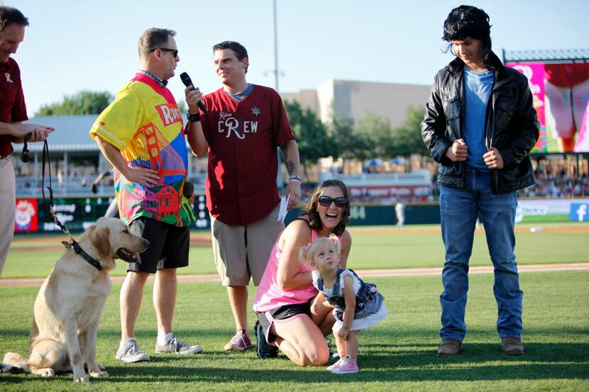 Full House star Dave Coulier talks on the field with Full House lookalikes in the middle of...
