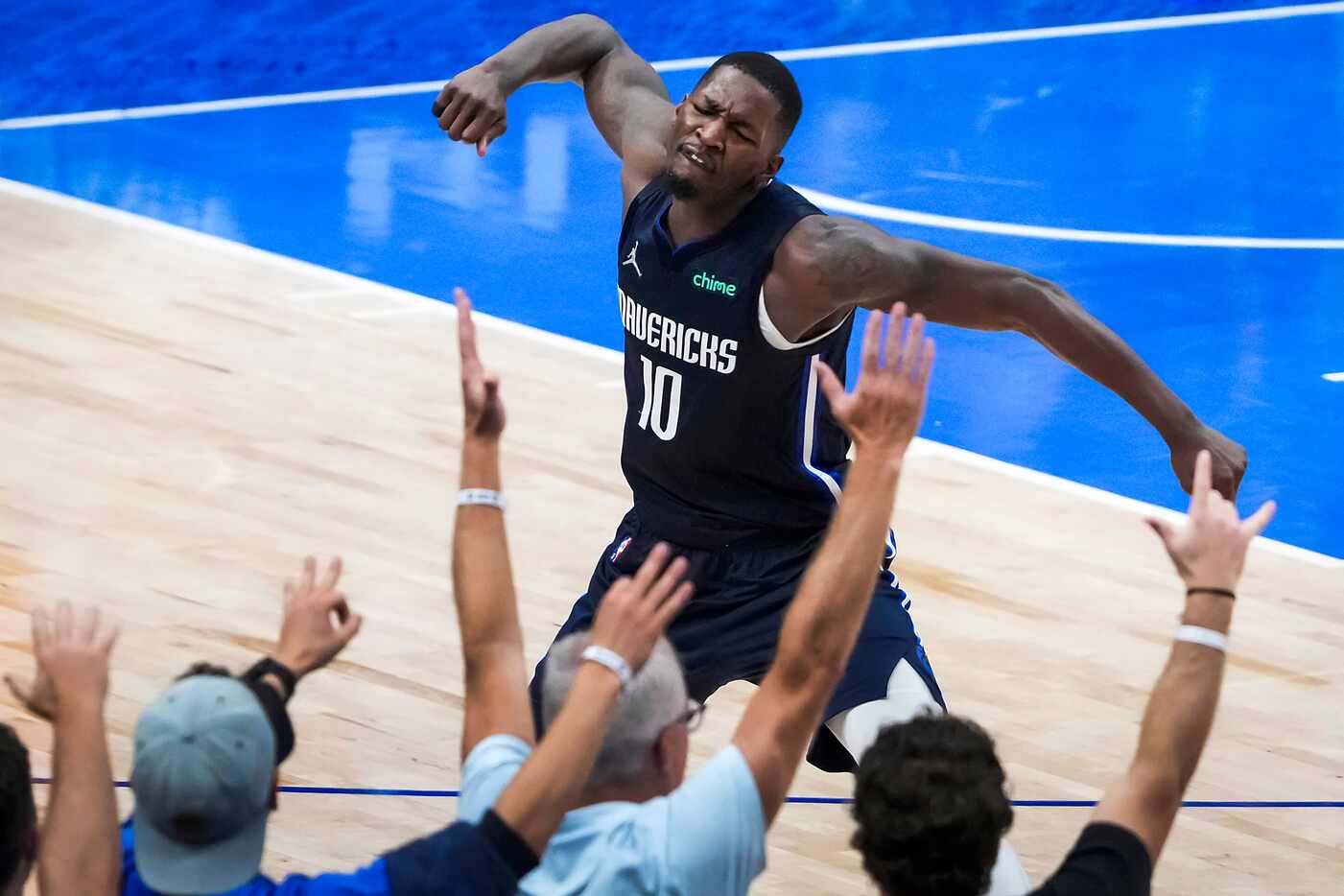 Dallas Mavericks forward Dorian Finney-Smith celebrates after hitting a 3-pointer to give...