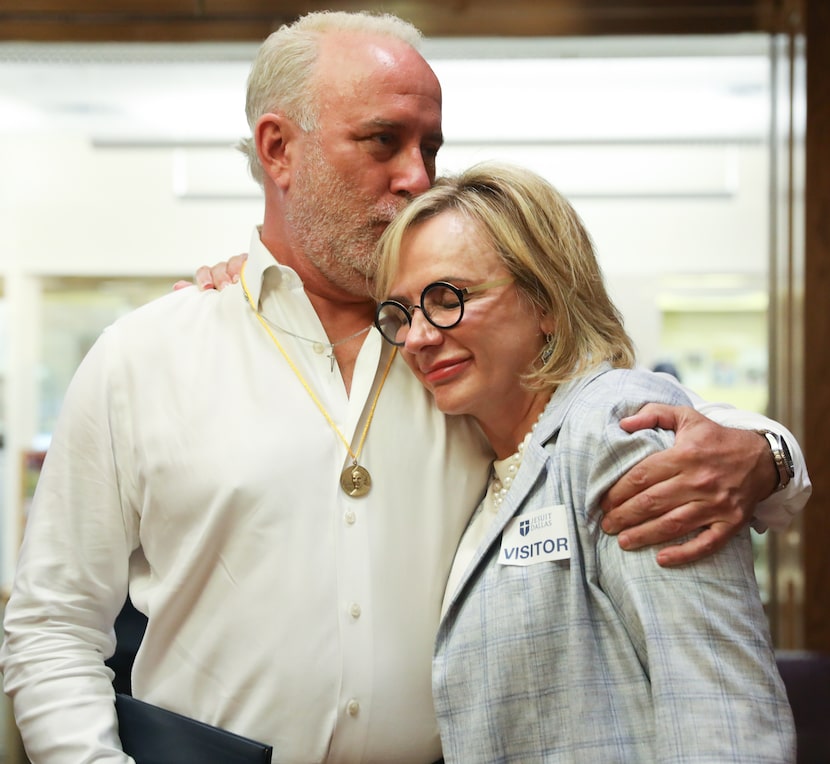 Brendan Higgins (right) kisses Dallas trial lawyer Charla Aldous on the head after receiving...