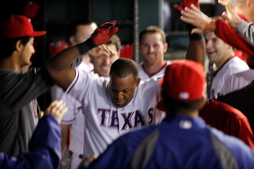 Texas Rangers Adrian Beltre ducks as he doesn't like pople touching his head as they...