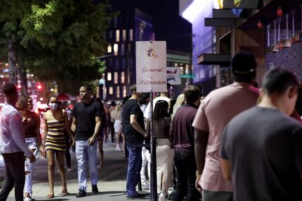 Guests wait in line outside of Bottled Blonde in Dallas on Sept. 11, 2020. 