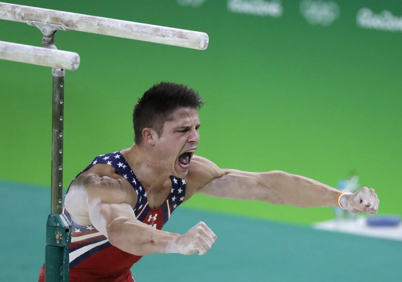 United States' Chris Brooks celebrates after his routine on the parallel bars during the...