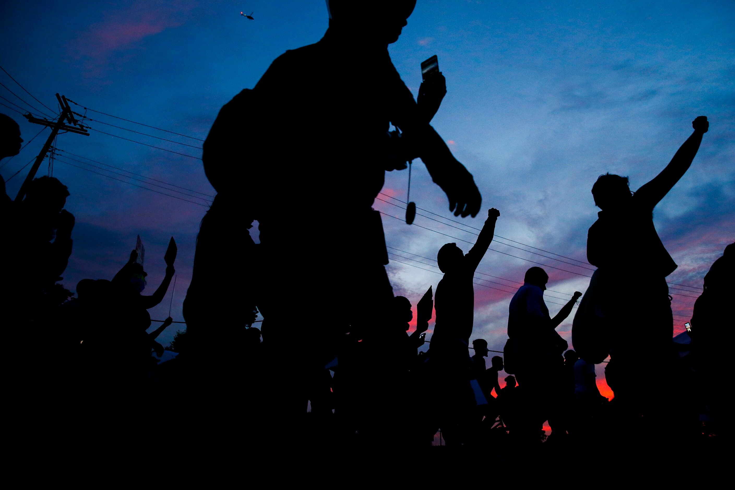 Protesters march to the Margaret Hunt Hill Bridge as they demonstrate against police...