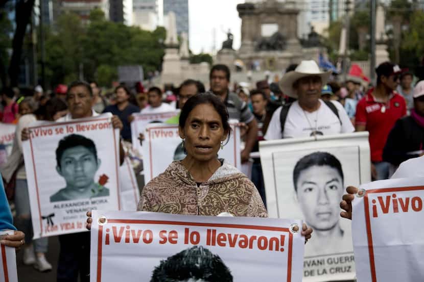 Marchers went through  the streets of Mexico City in August carrying banners bearing...