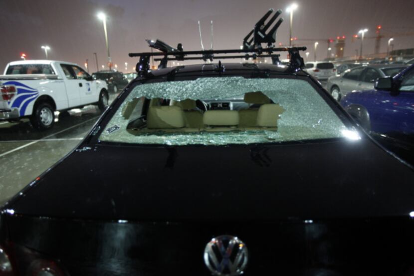 Hail took out the rear windshield of a car parked at Love Field Airport Tuesday night.