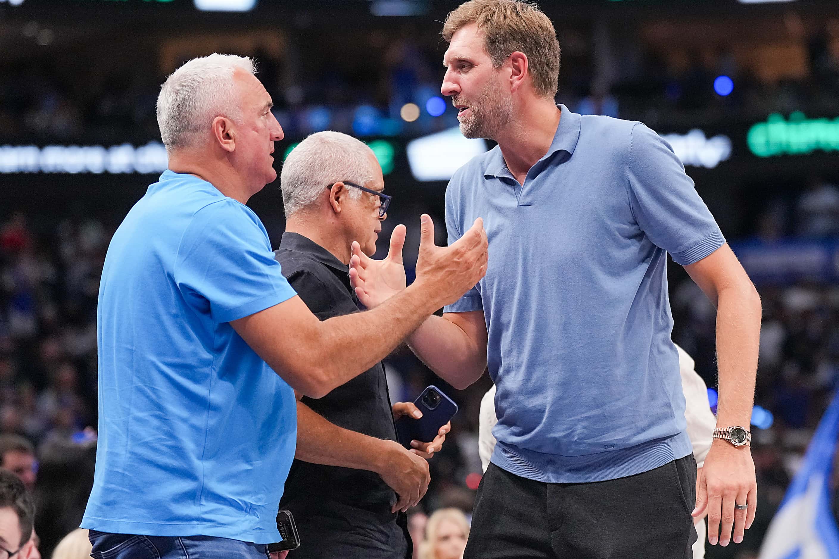 Dirk Nowitzki shakes hands with Luka Doncic’s father Sasa Doncic during the second half of a...