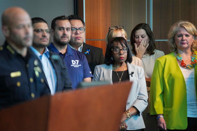 Dallas city council member Gay Donnell Willis wipes away tears as she stands with other...