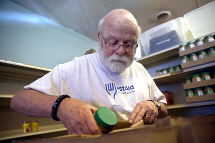 Dan Carlson packs a "gap bag" for someone at WestAid, a food pantry, in Fort Worth on Oct....