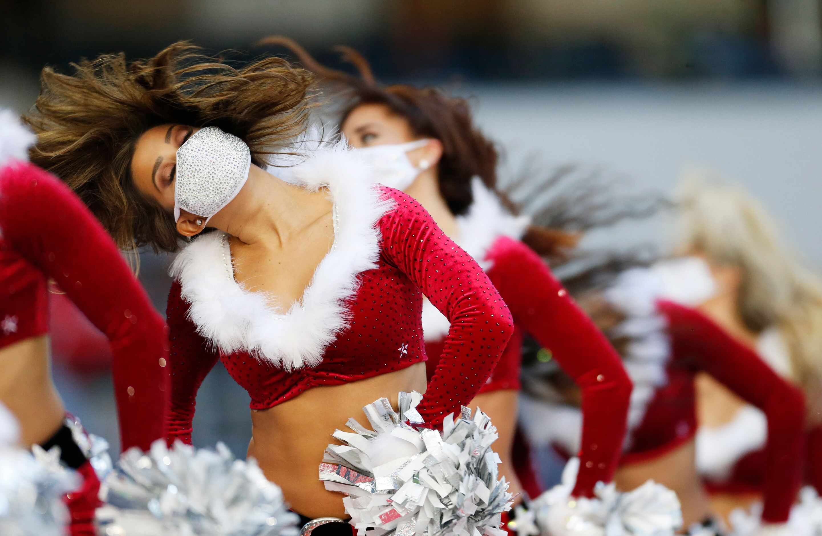Dallas Cowboys cheerleaders perform in holiday themed outfits in a game against the San...