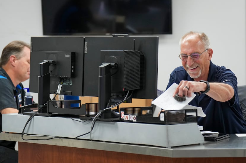 Chuck Korbish laughs with a colleague in the parts department at Huffines Chrysler Jeep...