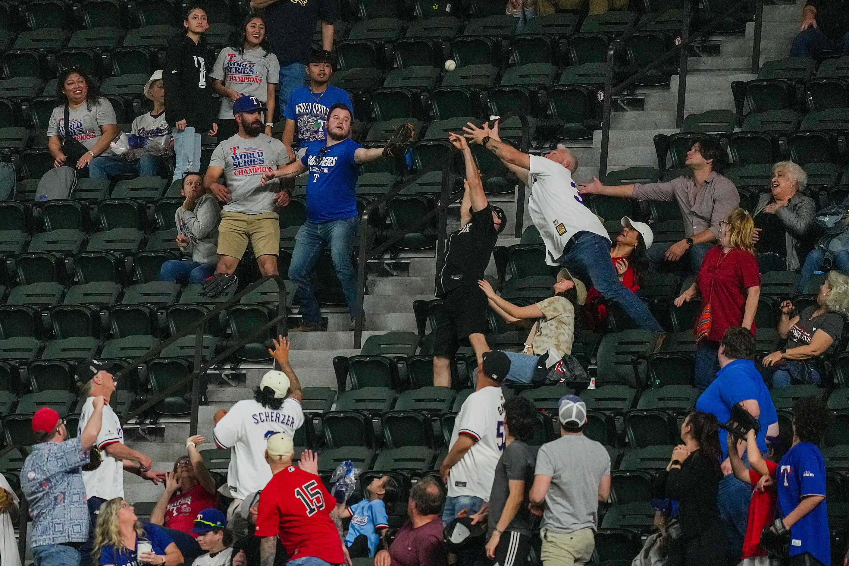 Fans reach for a home run off the bat of Enmanuel Valdez of the Boston Red Sox during the...