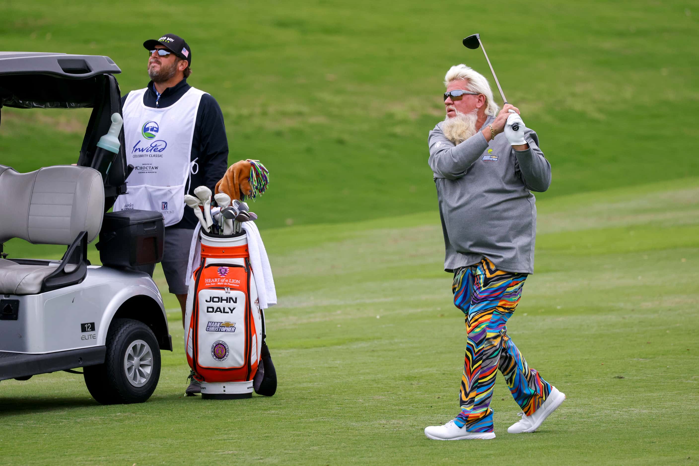 John Daly plays a shot from the 18th fairway during the first round of the Invited Celebrity...